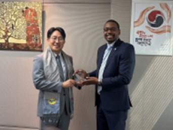 KOSTI presenting a plaque to a Cambodian delegate